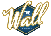 Logo hexagonal avec le texte "THE Wall" en cursive dorée sur fond bleu, accompagné de la mention "Live Game Show"